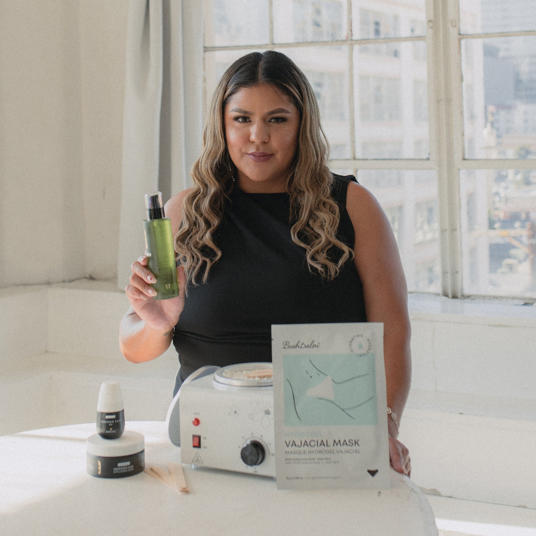 A person showcasing skincare products in a bright room.